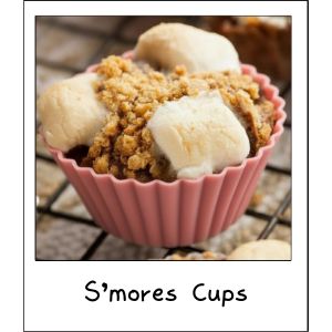 Close-up of homemade s’more cookie cups baked in silicone muffin liners with graham cracker crumble, melted chocolate chips, and toasted mini marshmallows on top.